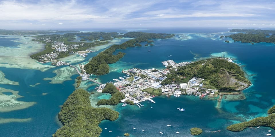 aerial photo of ocean, islands and housing area in Palau